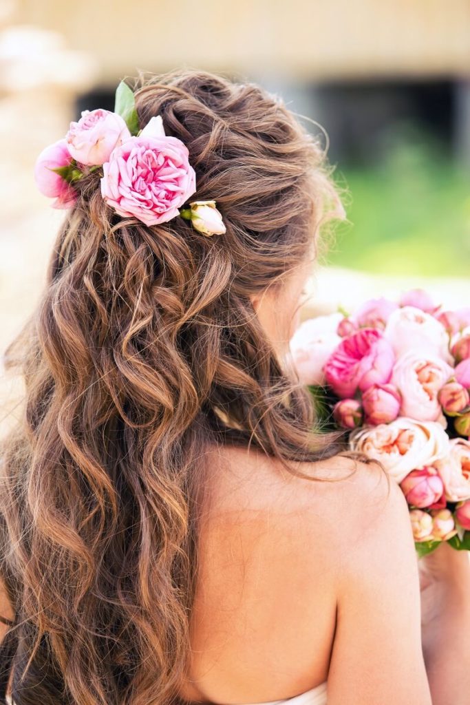 Brautfrisur halboffen mit Rosa Haarblumen